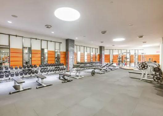 60 Riverside Boulevard, Unit 623 Manhattan, NY 10069 - Photo 8 of 12 a room with gym equipment and large window