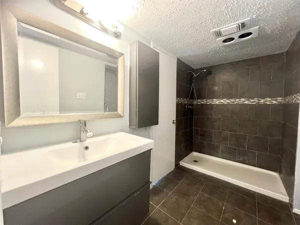 a bathroom with a bathtub a sink and a shower
