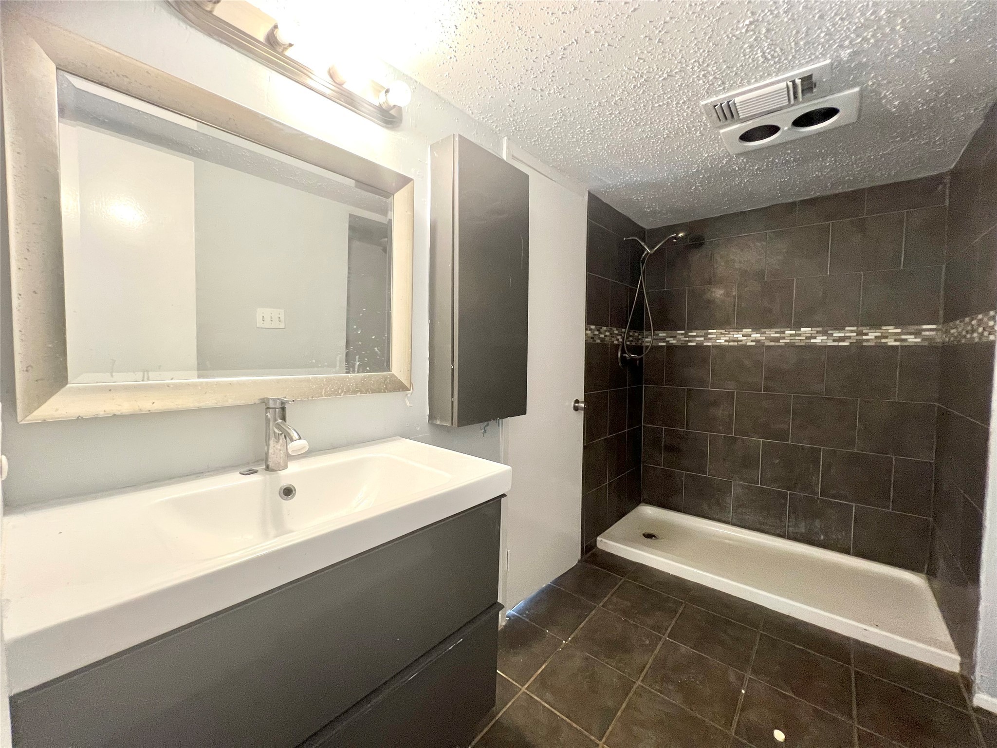 3754 Tanglewilde Street, Unit 9 Houston, TX 77063 - Photo 13 of 26 a bathroom with a bathtub a sink and a shower