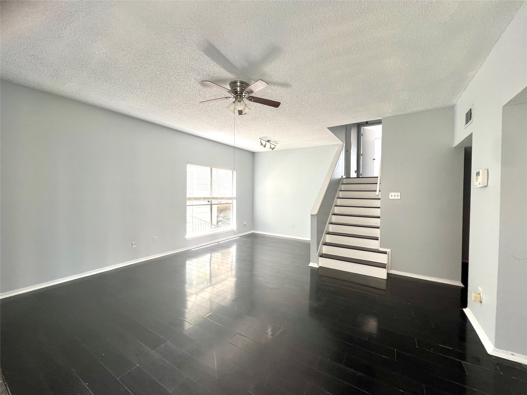 3754 Tanglewilde Street, Unit 9 Houston, TX 77063 - Photo 20 of 26 a view of an empty room with wooden floor and a window