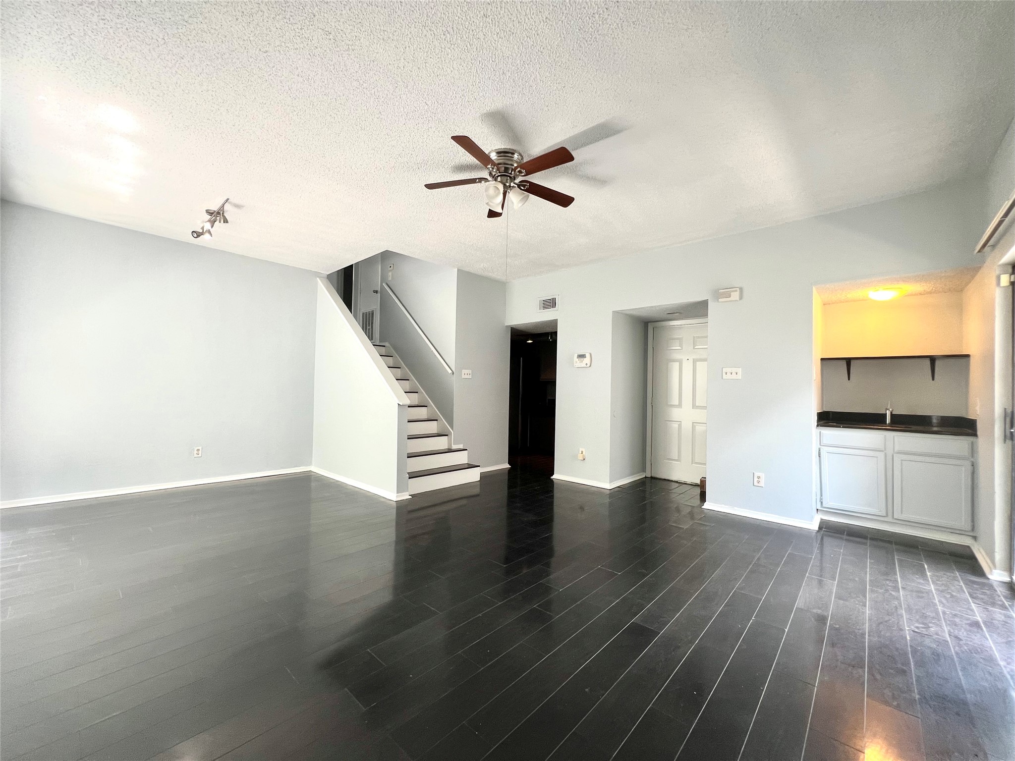 3754 Tanglewilde Street, Unit 9 Houston, TX 77063 - Photo 2 of 26 a view of an empty room with a window and wooden floor