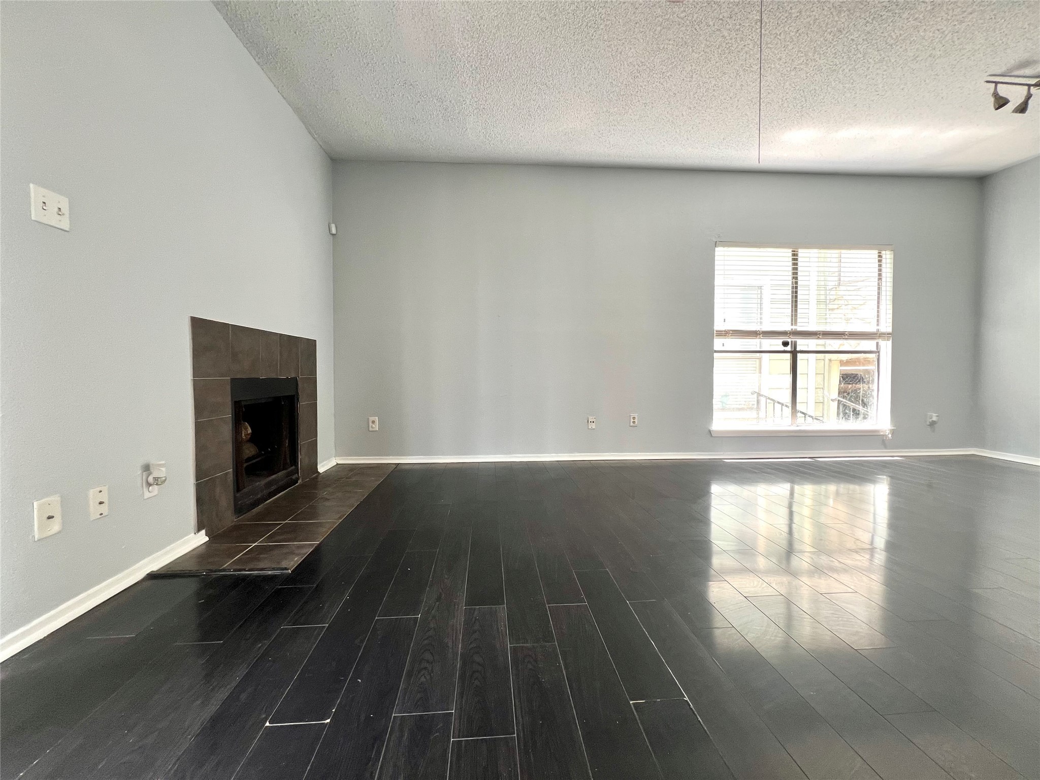 3754 Tanglewilde Street, Unit 9 Houston, TX 77063 - Photo 21 of 26 wooden floor in an empty room with a window