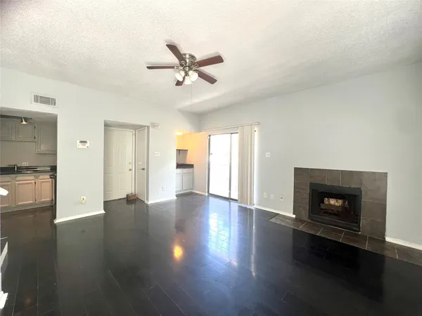 a view of a livingroom with a fireplace and wooden floor