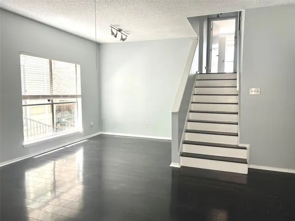 a view of a livingroom with wooden floor and window