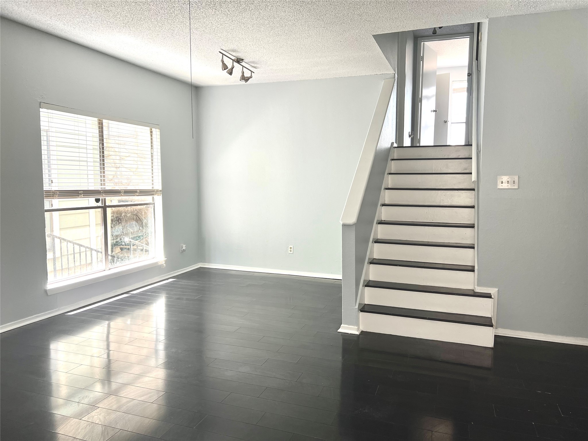 3754 Tanglewilde Street, Unit 9 Houston, TX 77063 - Photo 5 of 26 a view of a livingroom with wooden floor and window