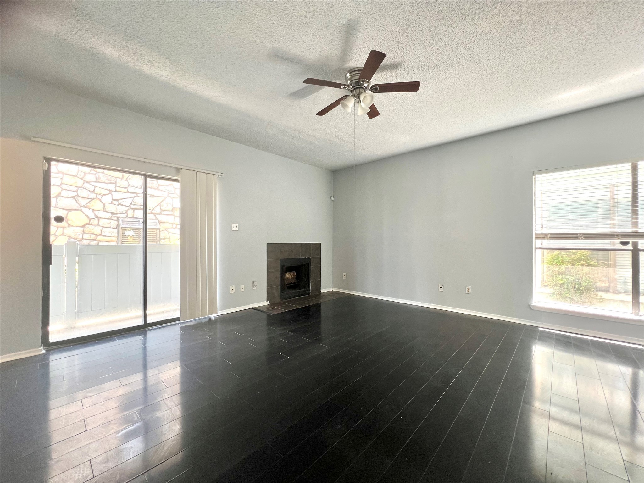 3754 Tanglewilde Street, Unit 9 Houston, TX 77063 - Photo 7 of 26 a view of an empty room with wooden floor and a window