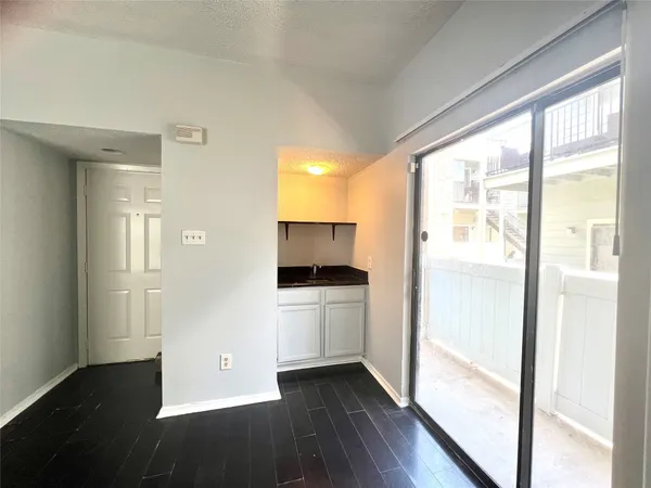 a kitchen with a refrigerator and a stove
