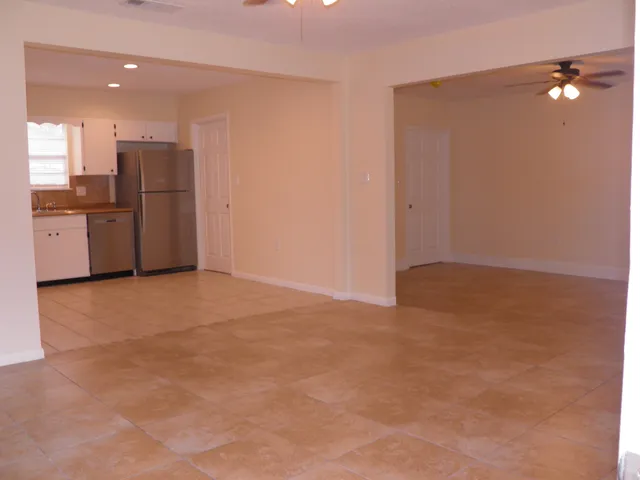 a view of kitchen with refrigerator and microwave