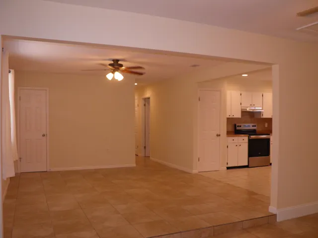 a view of a small space with wooden floor and a window