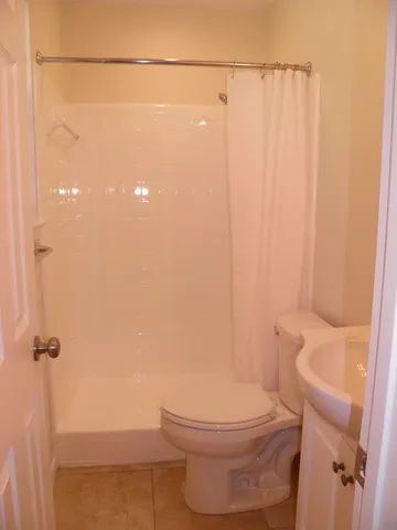 a bathroom with a shower and a sink