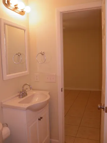 a view of a room with rack on the wall and a window