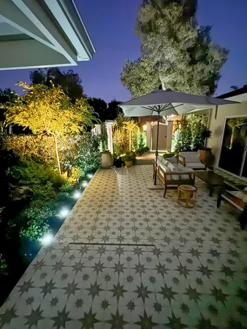 a view of a patio with table and chairs under an umbrella