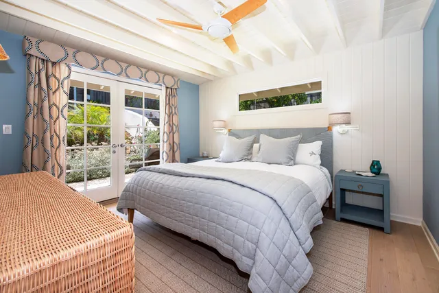 a bedroom with a bed wooden floor and window