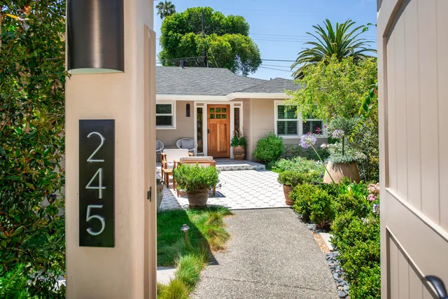 a front view of a house with a yard garage and outdoor seating