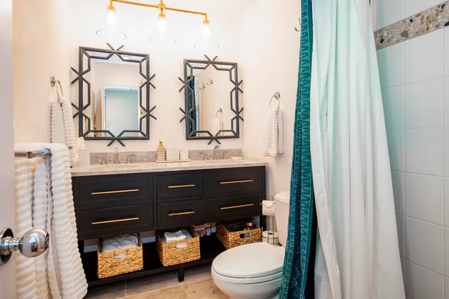 a bathroom with a sink a toilet and a mirror