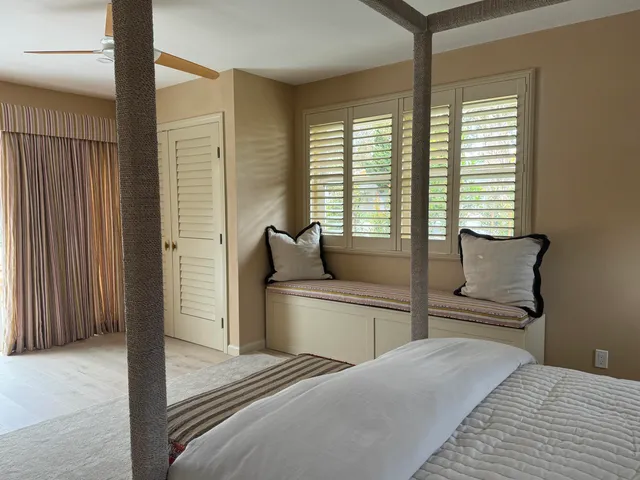 a bedroom with a large bed and a chandelier