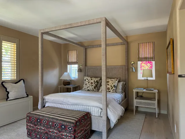 a bedroom with a bed a couch and dresser