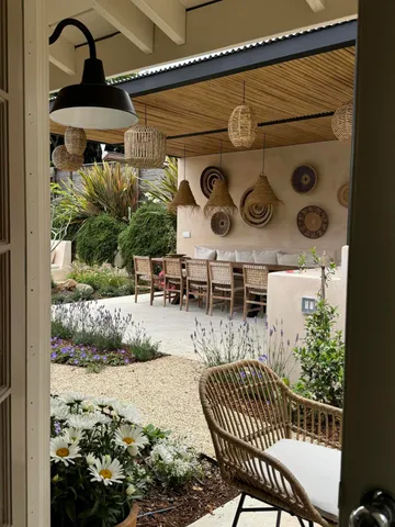 a view of a porch with furniture and plants