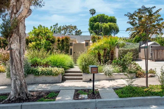 a street sign on a sidewalk next to a road