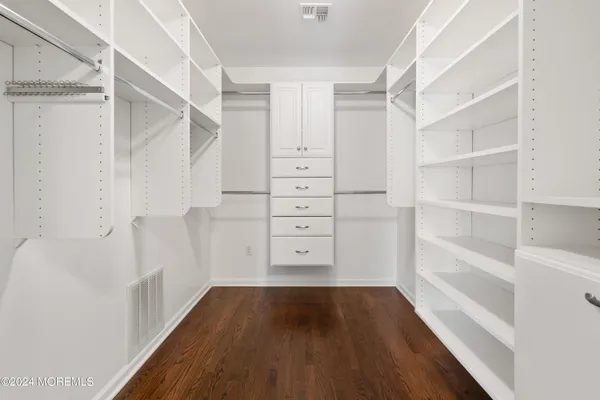 a view of walk in closet with empty racks