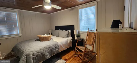 a bedroom with a bed and a flat tv screen