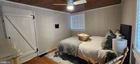a bedroom with a bed and a television