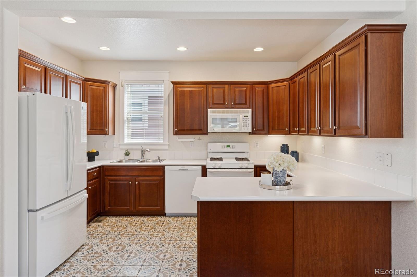 2872 Alton Street Denver, CO 80238 - Photo 13 of 46 a kitchen with stainless steel appliances granite countertop a sink stove and refrigerator