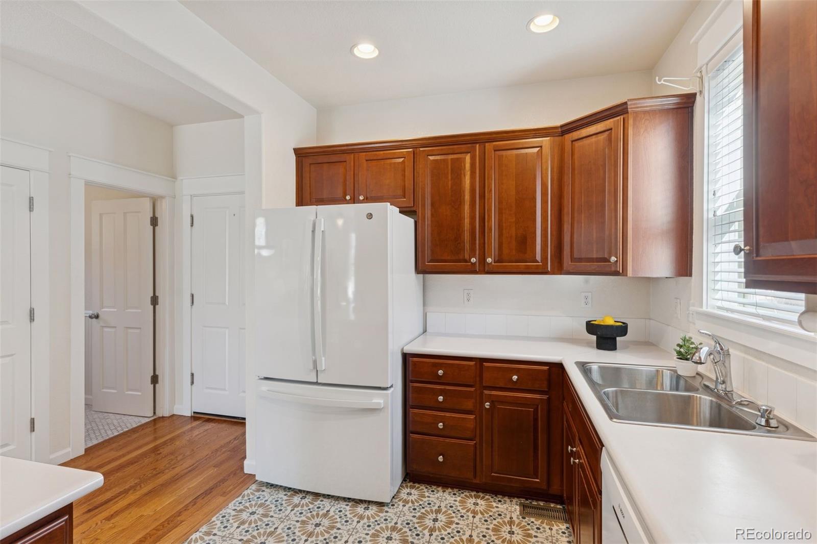 2872 Alton Street Denver, CO 80238 - Photo 15 of 46 a kitchen with a refrigerator and a sink
