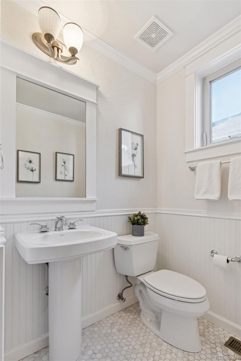 2872 Alton Street Denver, CO 80238 - Photo 16 of 46 a bathroom with a sink a toilet and mirror
