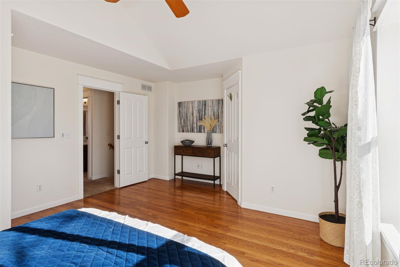 2872 Alton Street Denver, CO 80238 - Photo 20 of 46 a bedroom with a bed and a potted plant