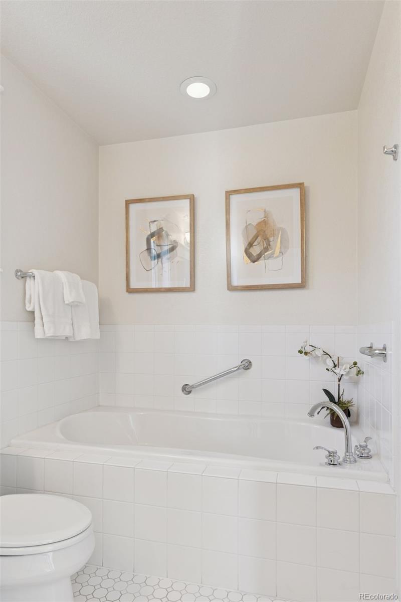 2872 Alton Street Denver, CO 80238 - Photo 22 of 46 a bathroom with a bathtub and a shower