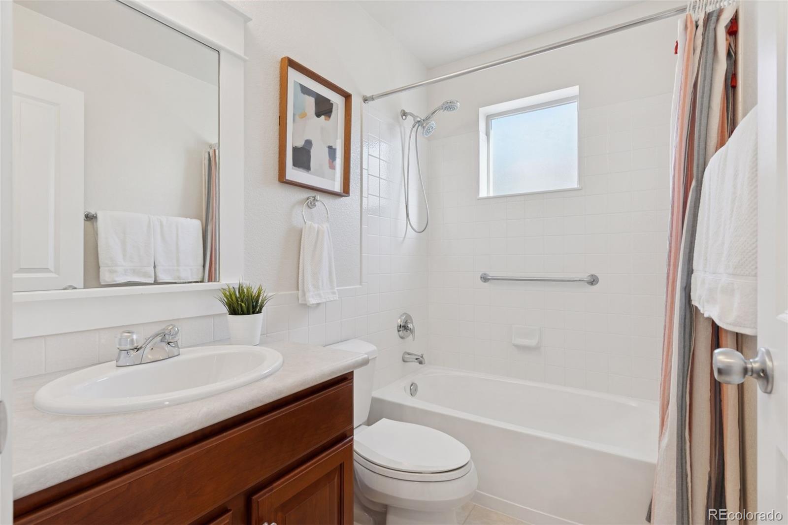 2872 Alton Street Denver, CO 80238 - Photo 27 of 46 a bathroom with a granite countertop sink toilet and shower