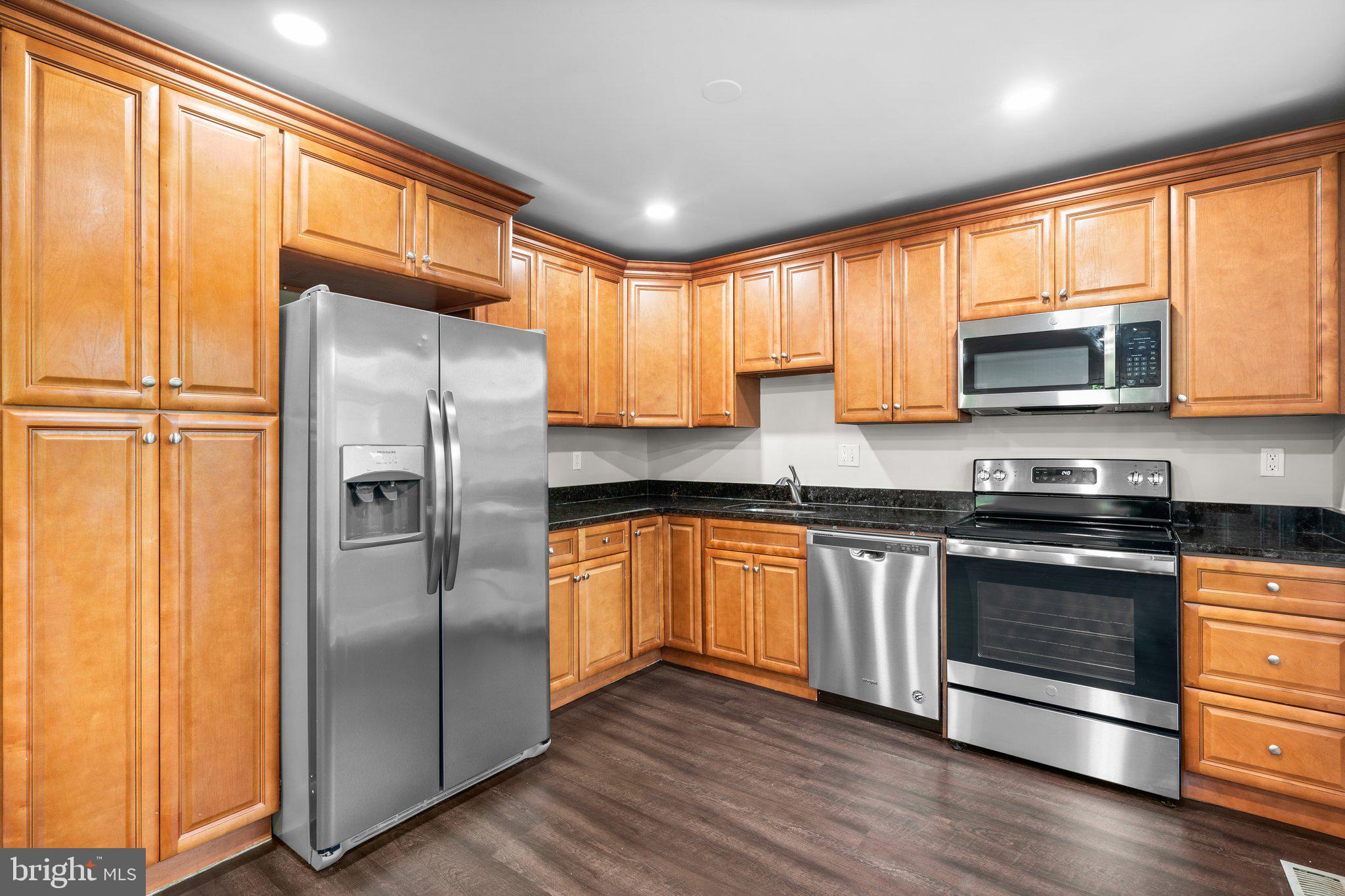2360 Albot Road Reston, VA 20191 - Photo 11 of 35 a kitchen with stainless steel appliances granite countertop a refrigerator microwave and sink