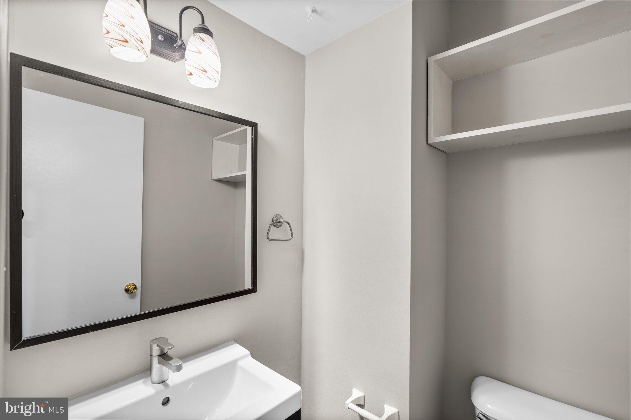 2360 Albot Road Reston, VA 20191 - Photo 13 of 35 a bathroom with a toilet sink and mirror