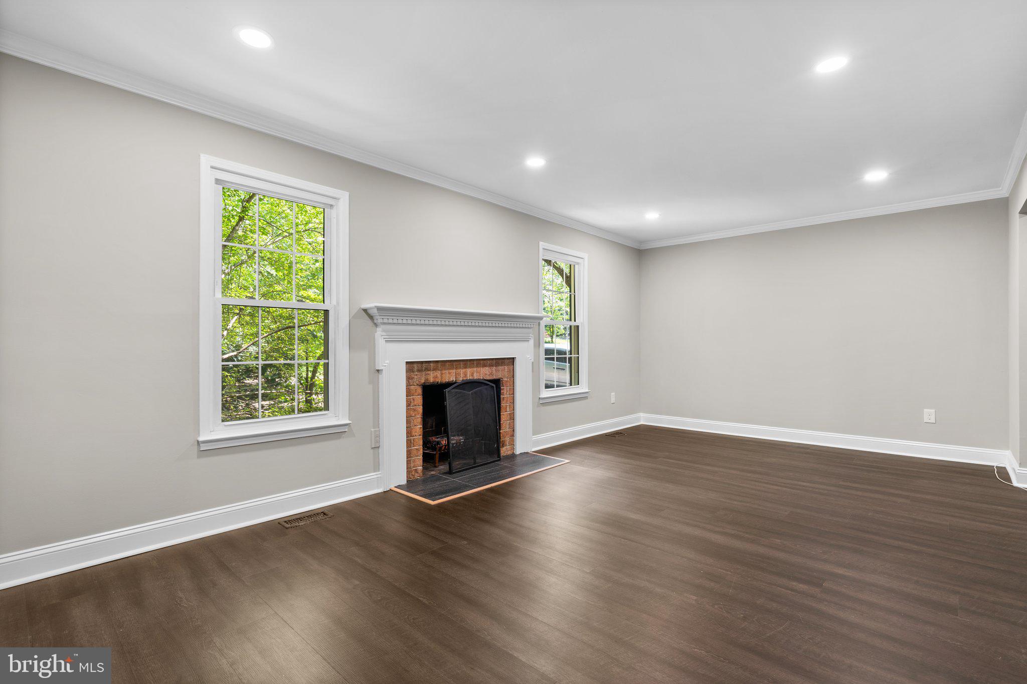 2360 Albot Road Reston, VA 20191 - Photo 5 of 35 an empty room with wooden floor fireplace and windows