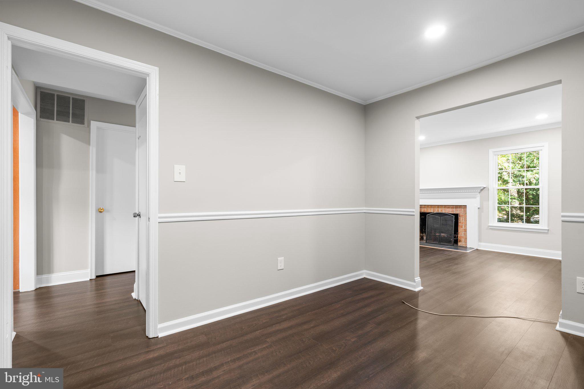 2360 Albot Road Reston, VA 20191 - Photo 8 of 35 an empty room with wooden floor fireplace and windows