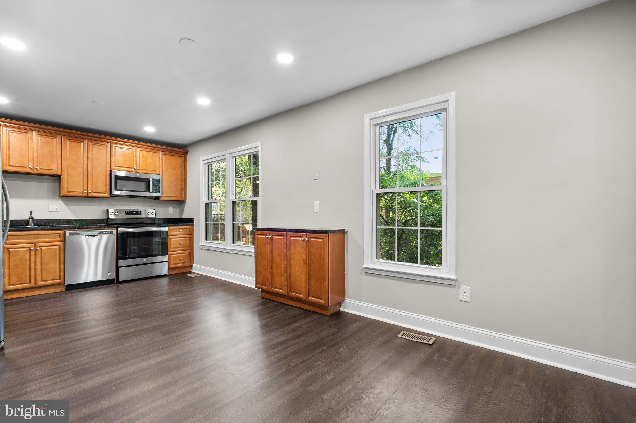 2360 Albot Road Reston, VA 20191 - Photo 9 of 35 an empty room with wooden floor and kitchen view