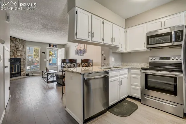 a kitchen with a stove oven and sink