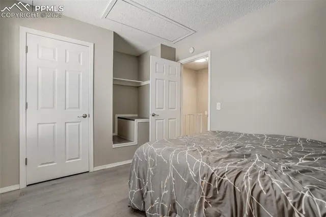 a bedroom with a bed and cabinets