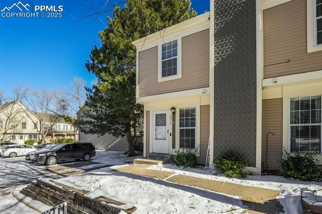 a view of the house with backyard and sitting area