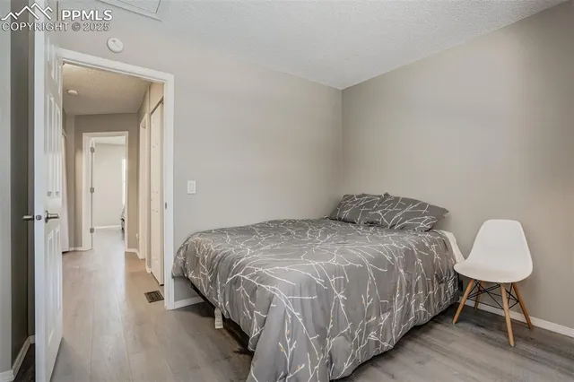 a bedroom with a bed and a chair