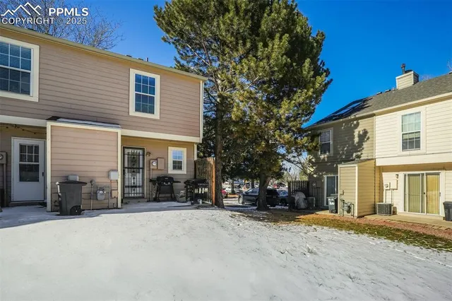 a view of a house with a snow in the road