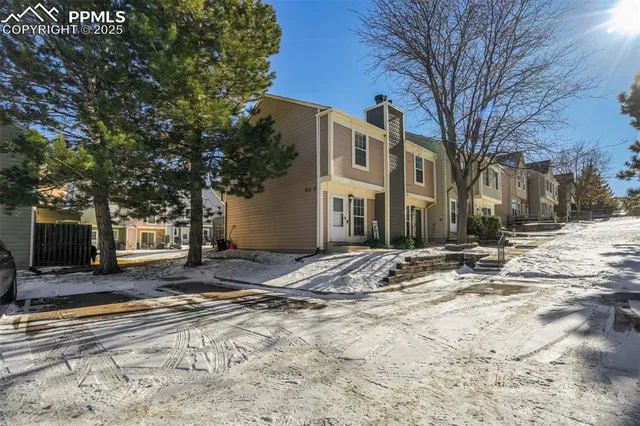 a view of a house with snow on the road