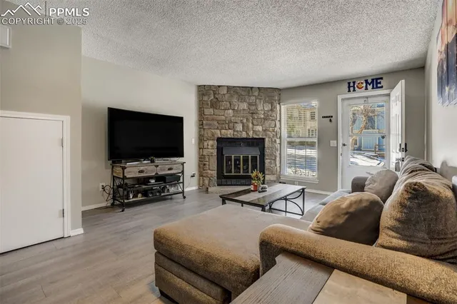 a living room with furniture flat screen tv and a fireplace