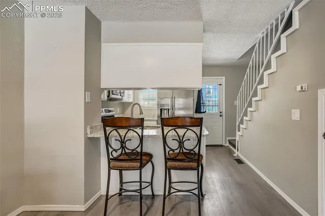 a table and chairs in a room and a window