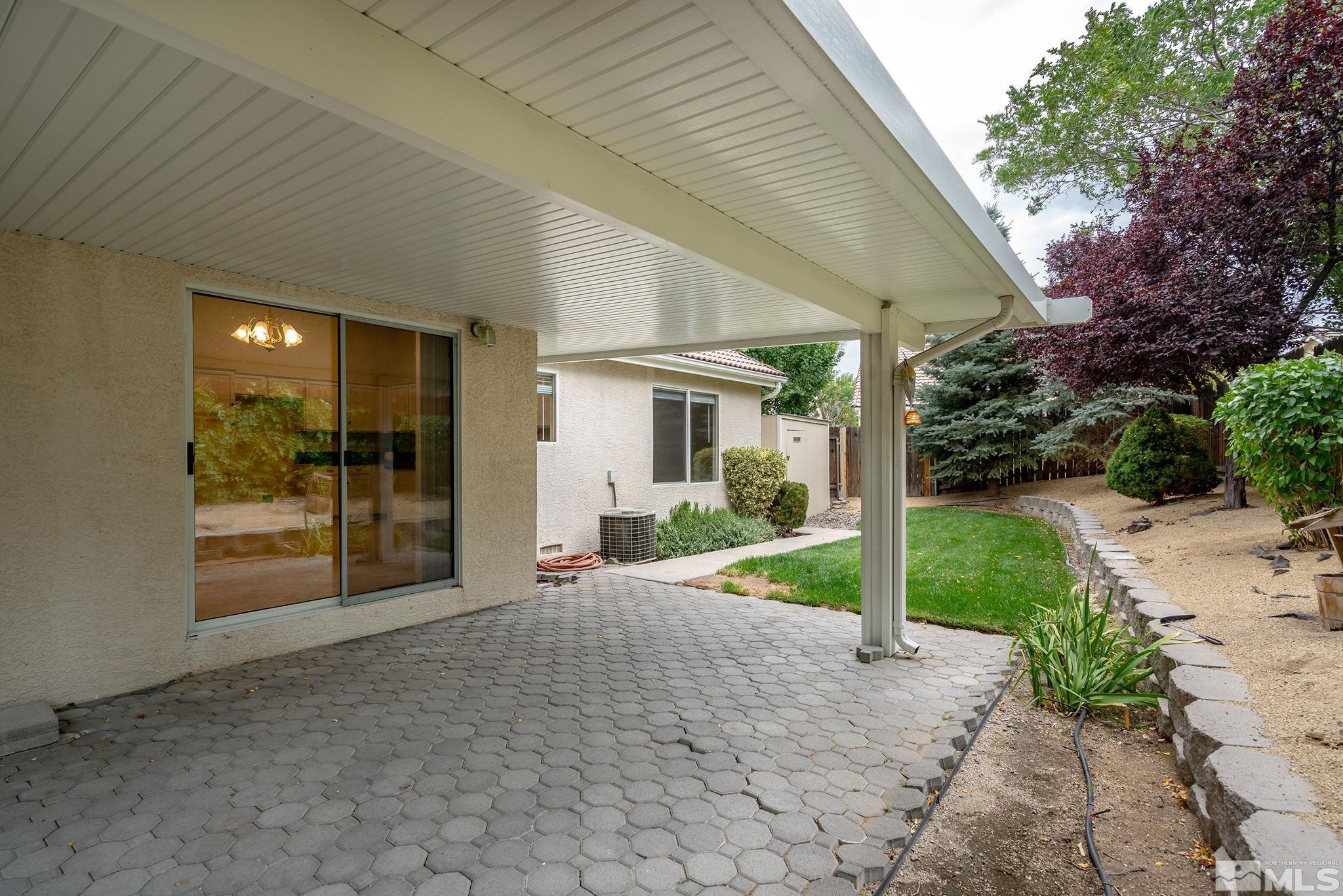9789 Thunder Mountain Way Reno, NV 89521 - Photo 13 of 17 a view of a house with backyard and porch