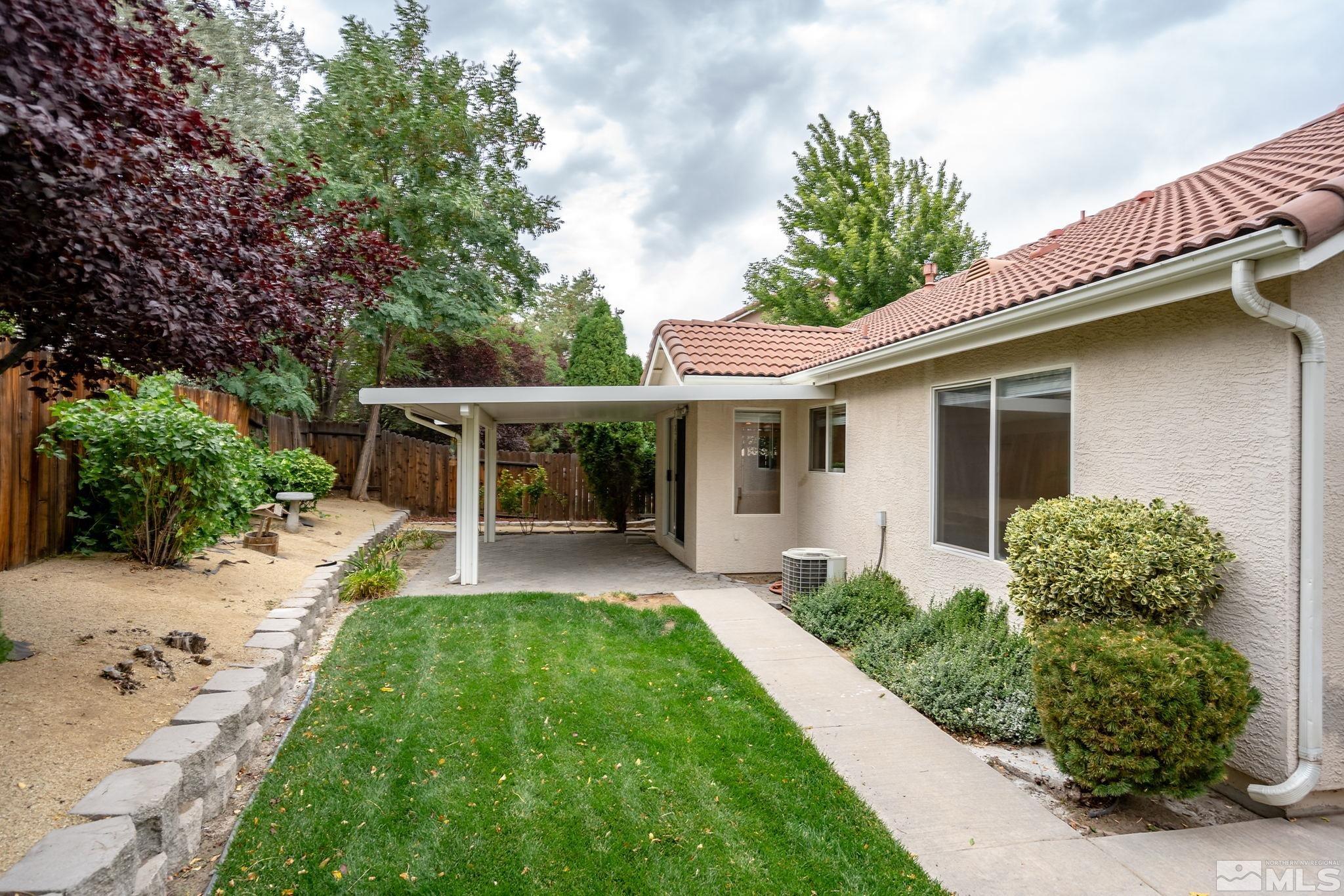 9789 Thunder Mountain Way Reno, NV 89521 - Photo 15 of 17 front view of a house with a yard