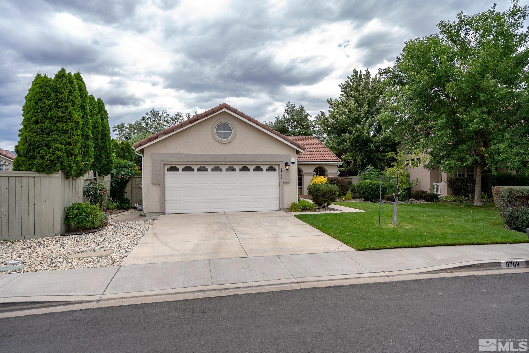 9789 Thunder Mountain Way Reno, NV 89521 - Photo 17 of 17 a view of a house with a yard and a large tree