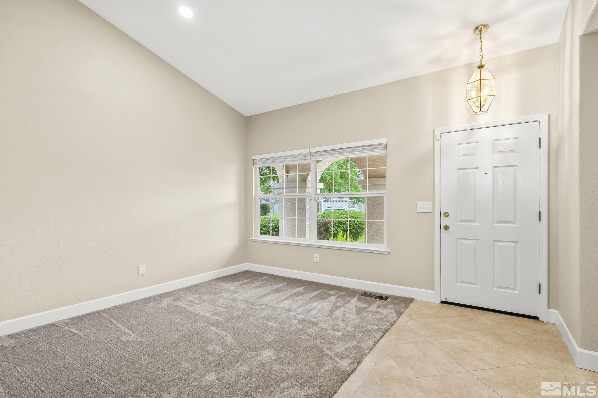 9789 Thunder Mountain Way Reno, NV 89521 - Photo 6 of 17 an empty room with windows