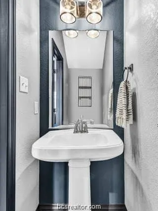 a view of kitchen island with sink and wooden floor